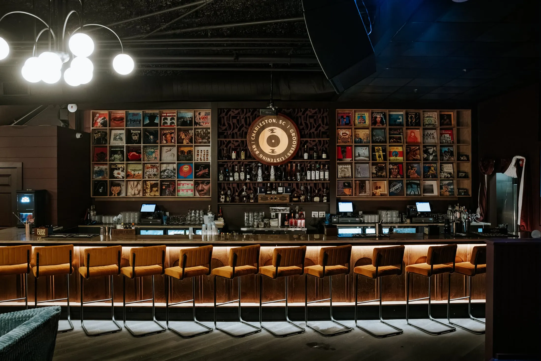 Groovers, straight on: the floor-to-ceiling record display wall behind the bar, and the bar front below the counter.