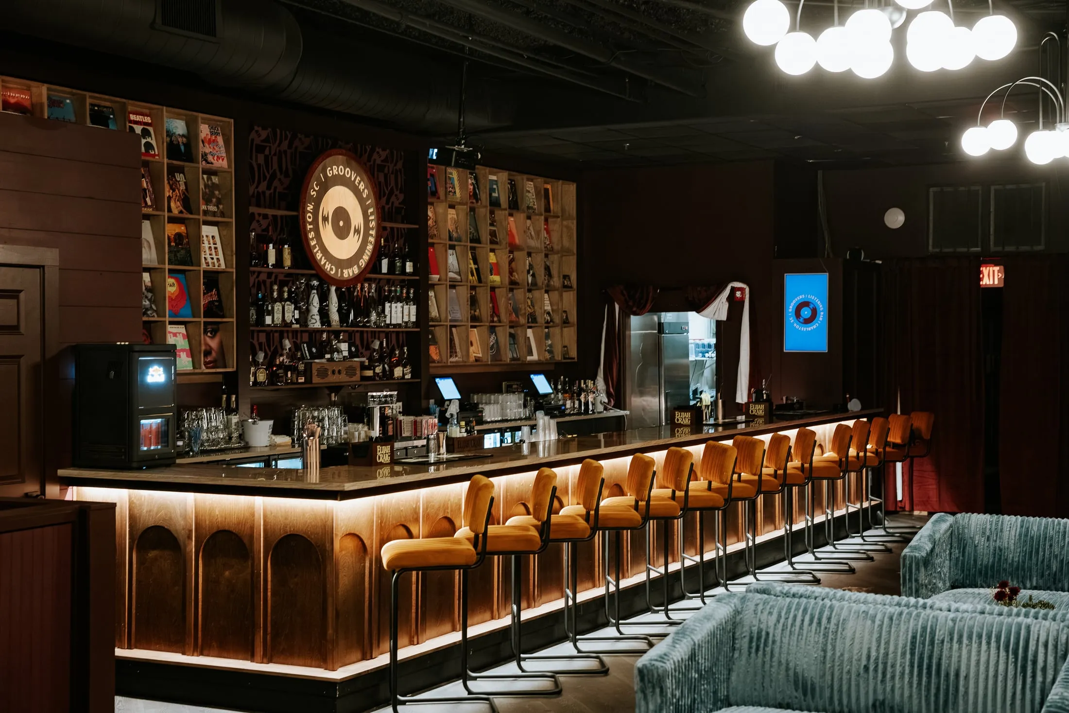 The fluted bar front and record display wall at Groovers, from the lounge.