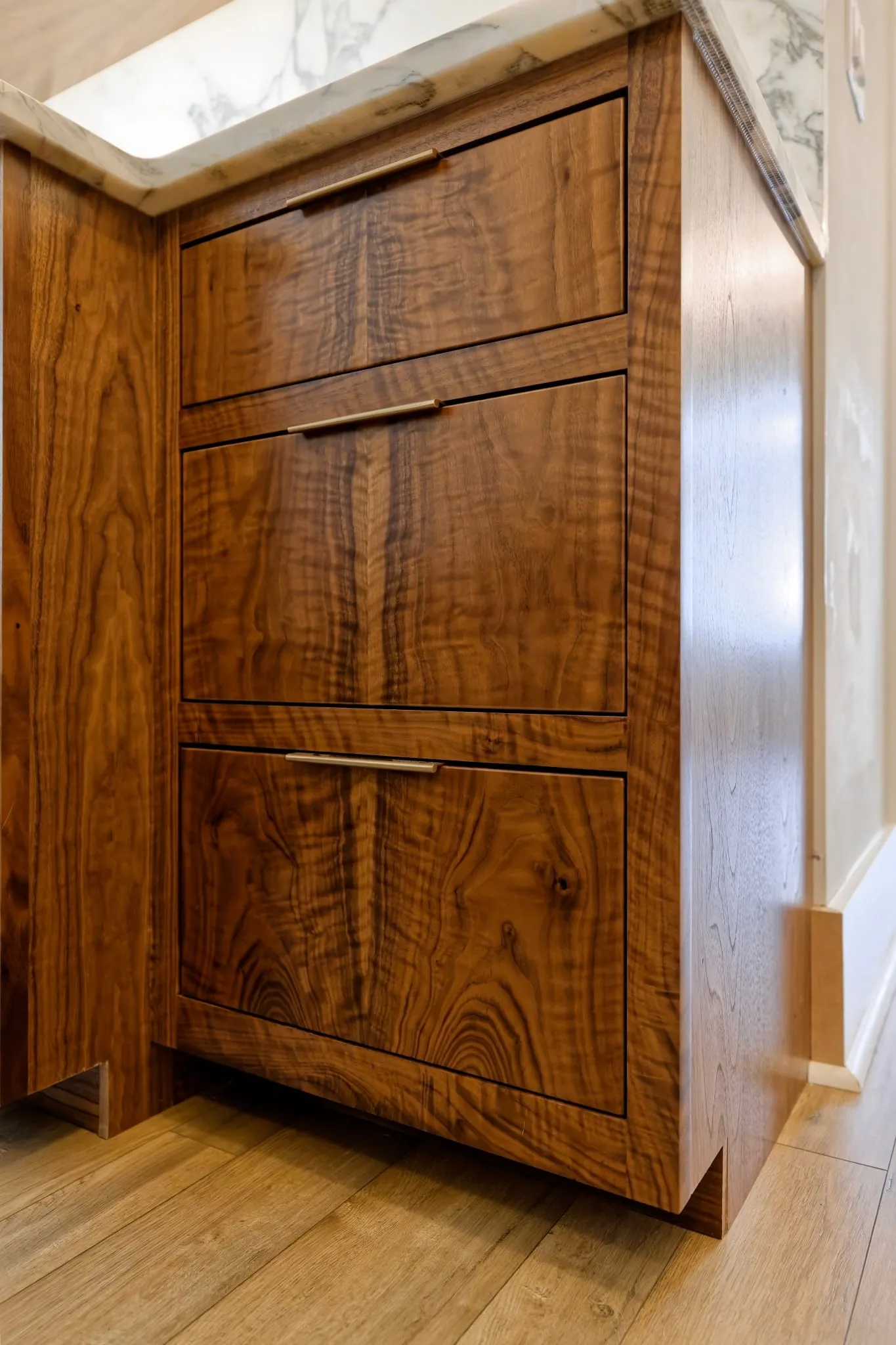 Tall run of figured walnut drawers at the end of the bar.