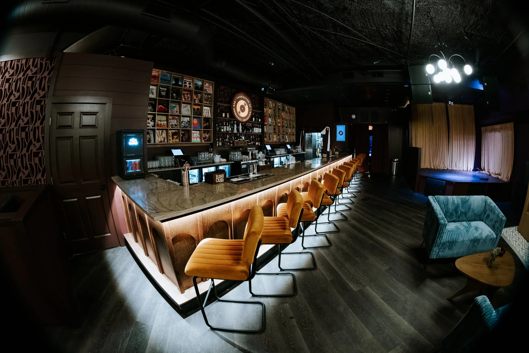 Groovers' bar front at an angle, underlit, running toward the back of the room.