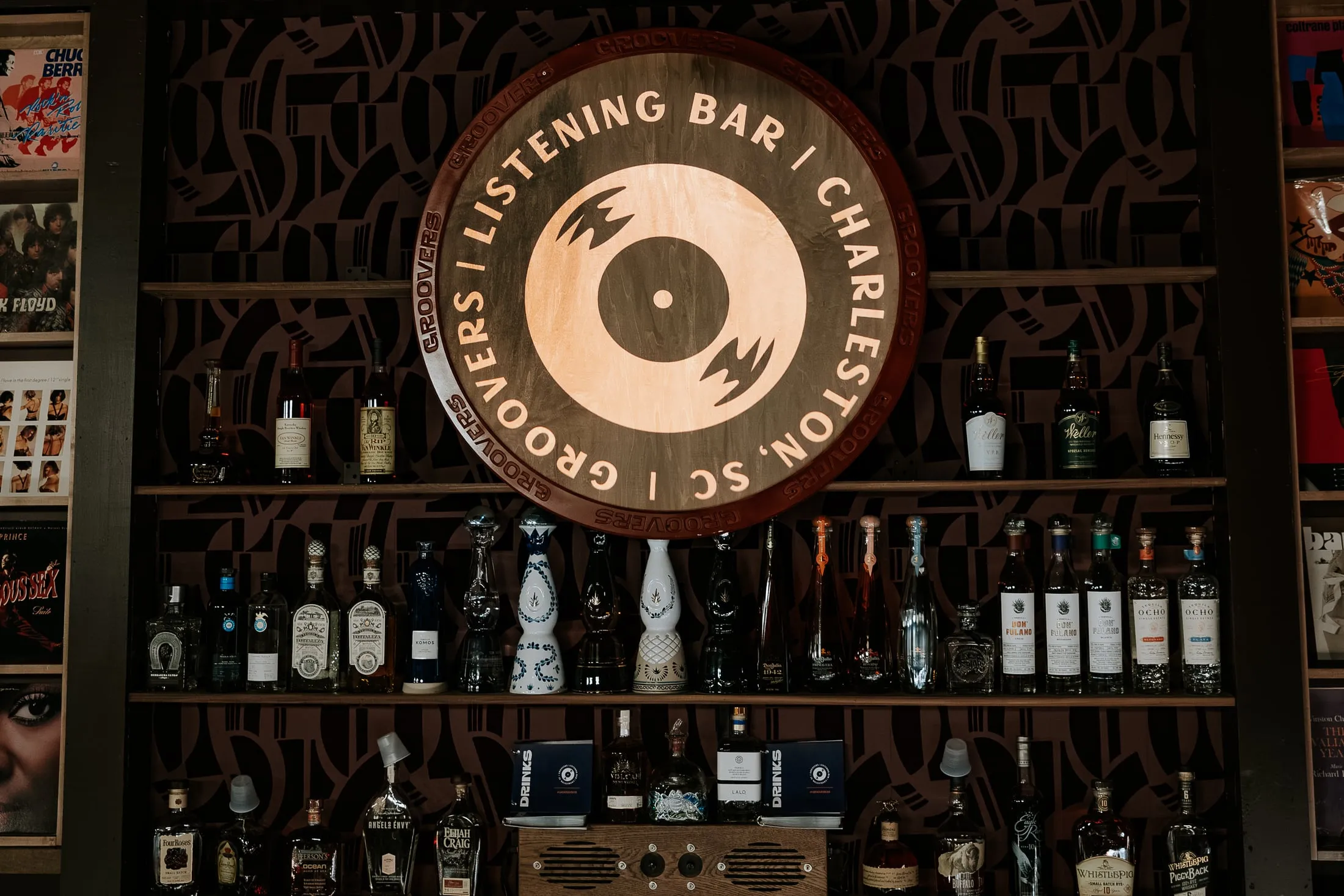 Close-up of the record display wall at Groovers, around the bar's logo sign.