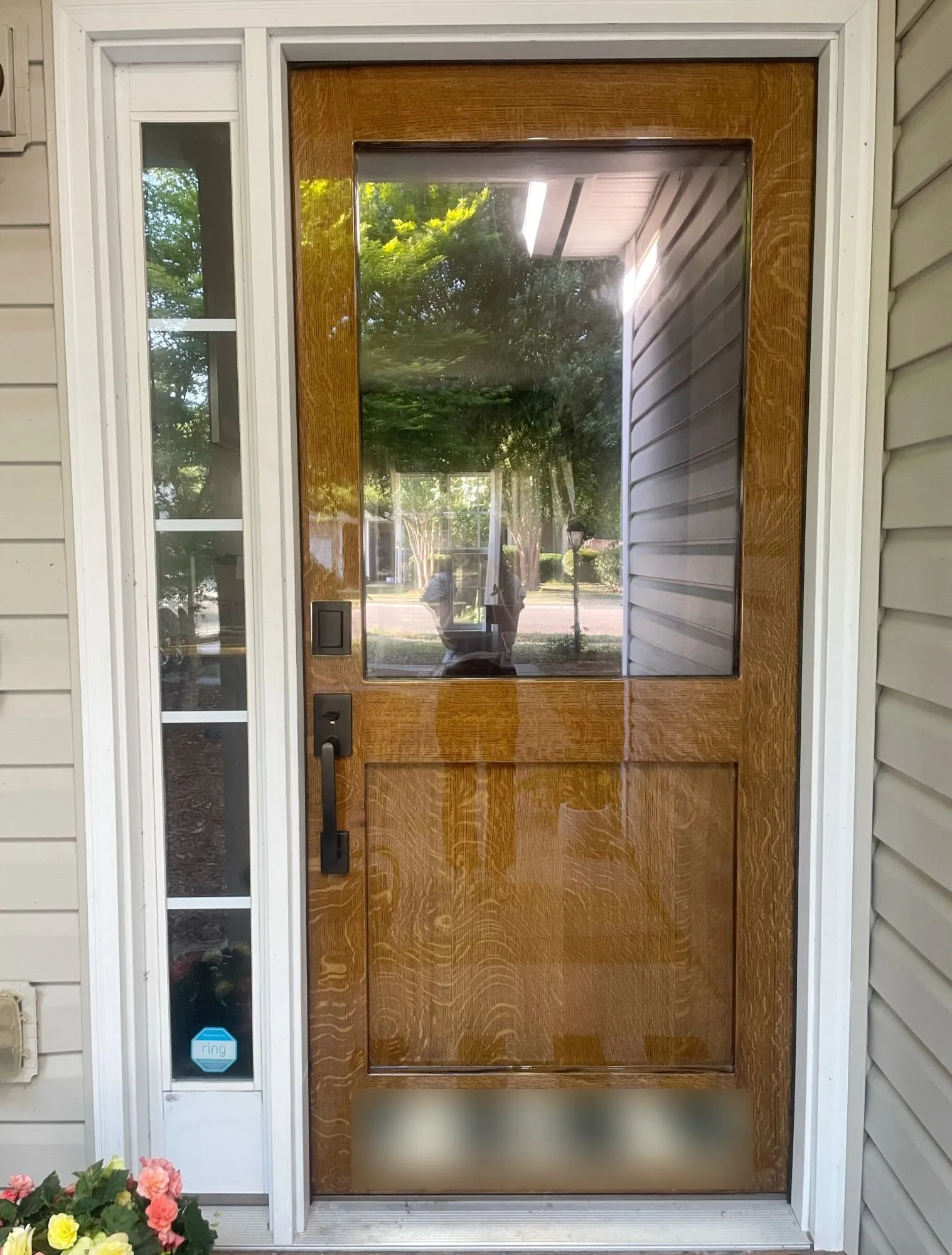Quarter-sawn white oak front door with a large glass lite and a raised lower panel, in a high-gloss finish.